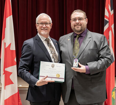 Receiving the Coronation Medal for Community Service